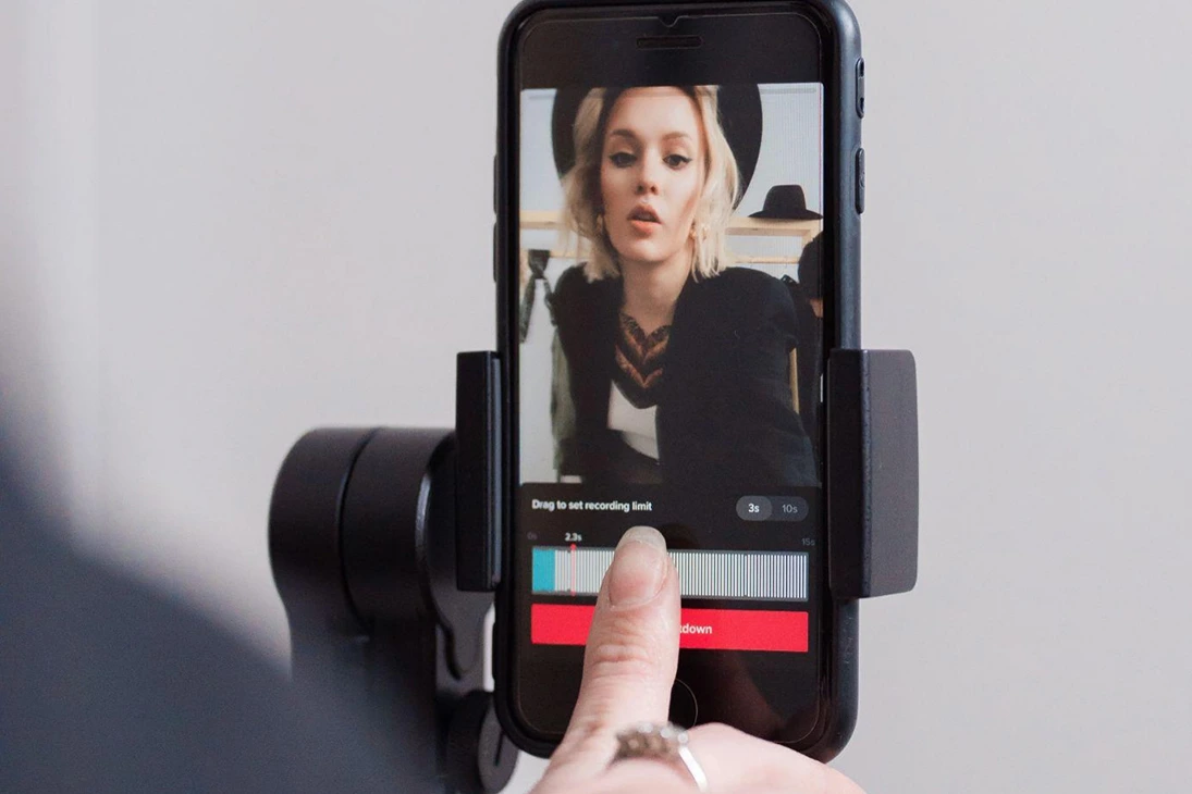 Smartphone recording a creator, representing TikTok marketing, short-form video content, and social media strategy.