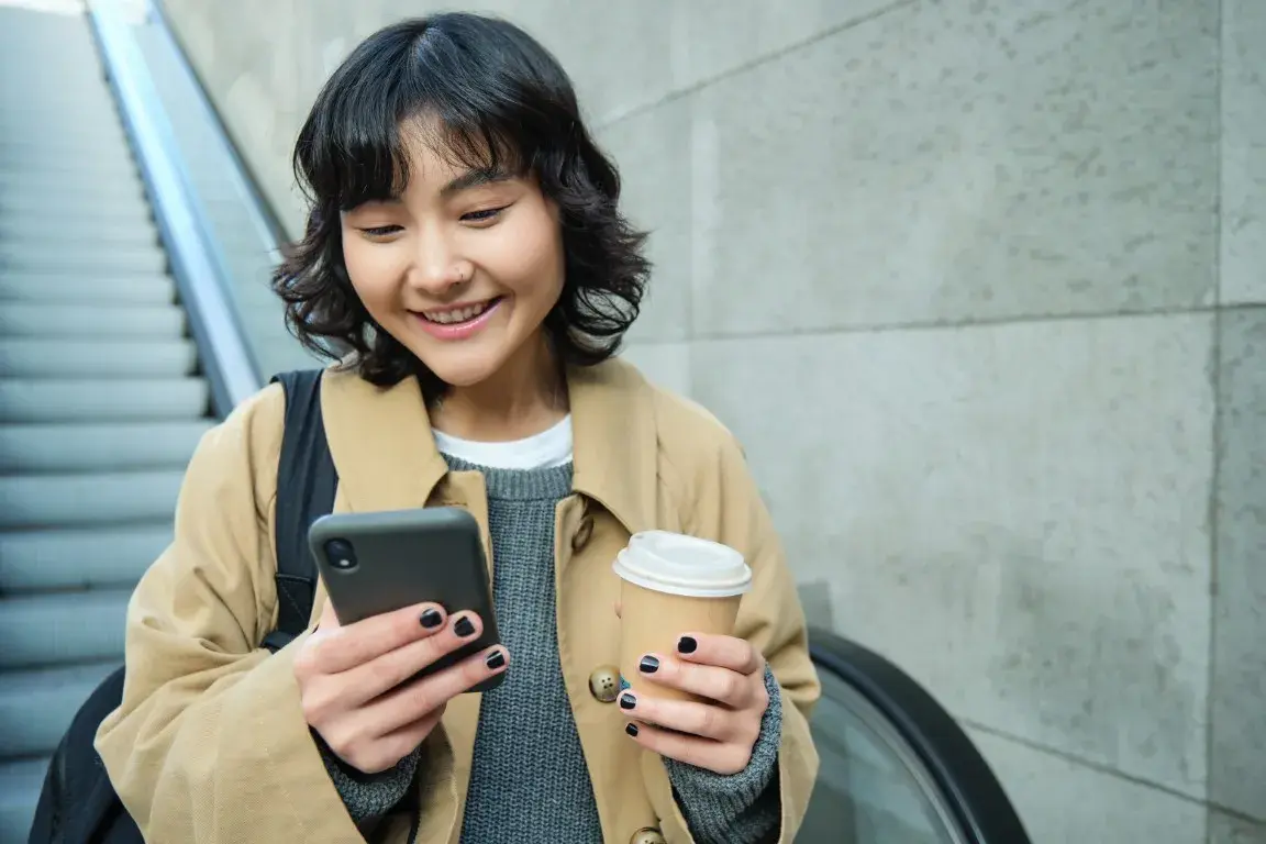 A woman searches an AI platform on her phone for a local business.