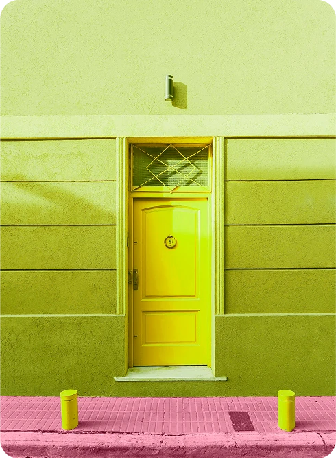 Bright yellow storefront with pink sidewalk, representing creative brand photography and bold visual identity design.